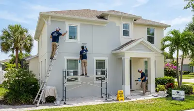 Professional house painters refreshing exterior home color in Cape Coral FL