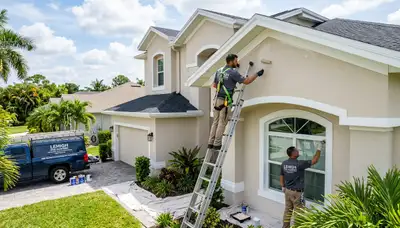 Professional house painters finishing exterior home project in Cape Coral FL