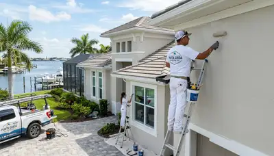 Professional house painters working on exterior home repainting in Cape Coral FL