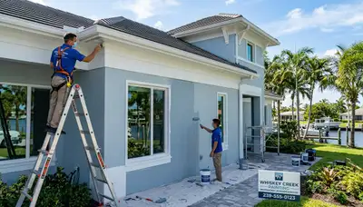 Professional house painters working on exterior home in Cape Coral FL